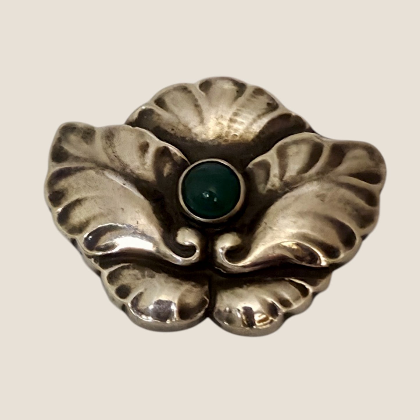 Georg Jensen, Denmark. No. 107. Silver brooch with a green cabochon stone