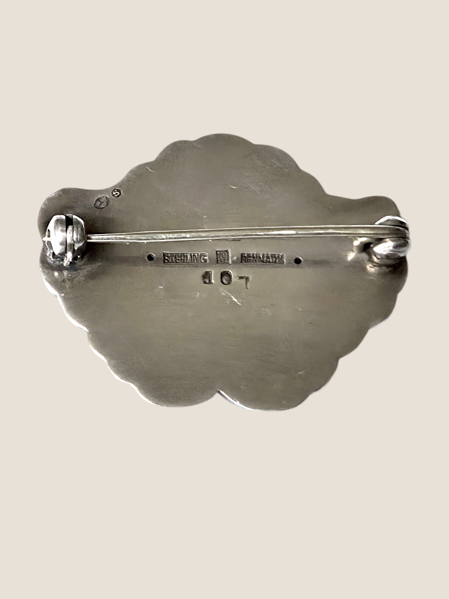 Georg Jensen, Denmark. No. 107. Silver brooch with a green cabochon stone